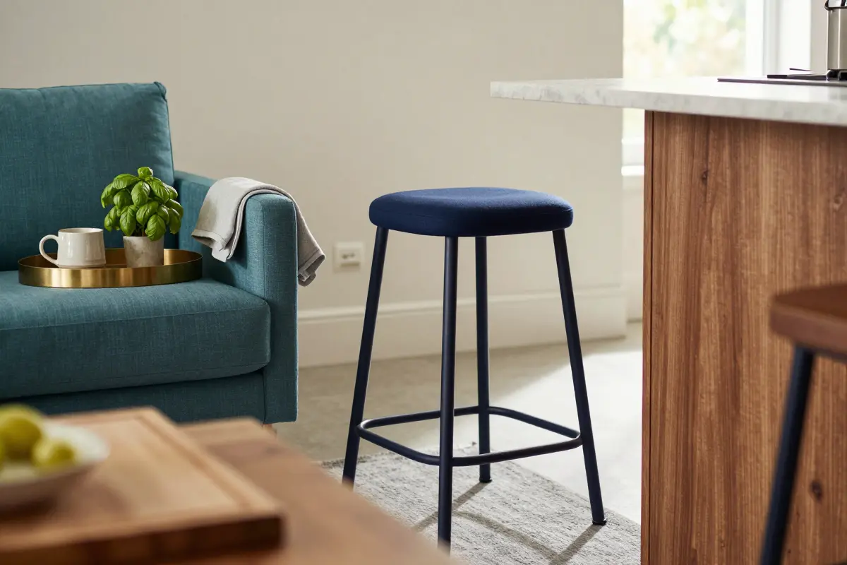 Navy upholstered counter stools at a kitchen island matching a navy accent chair
